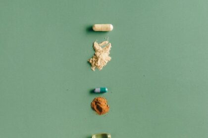 assorted capsules and a spoon with syrup
